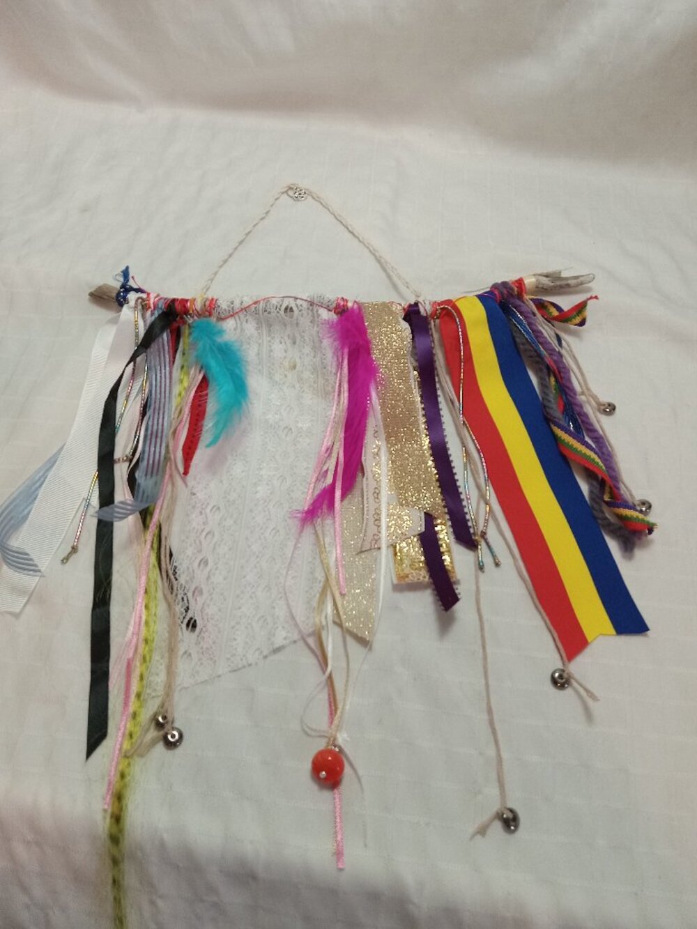 Handcrafted artistic banner made from treated driftwood, ribbons & decorations